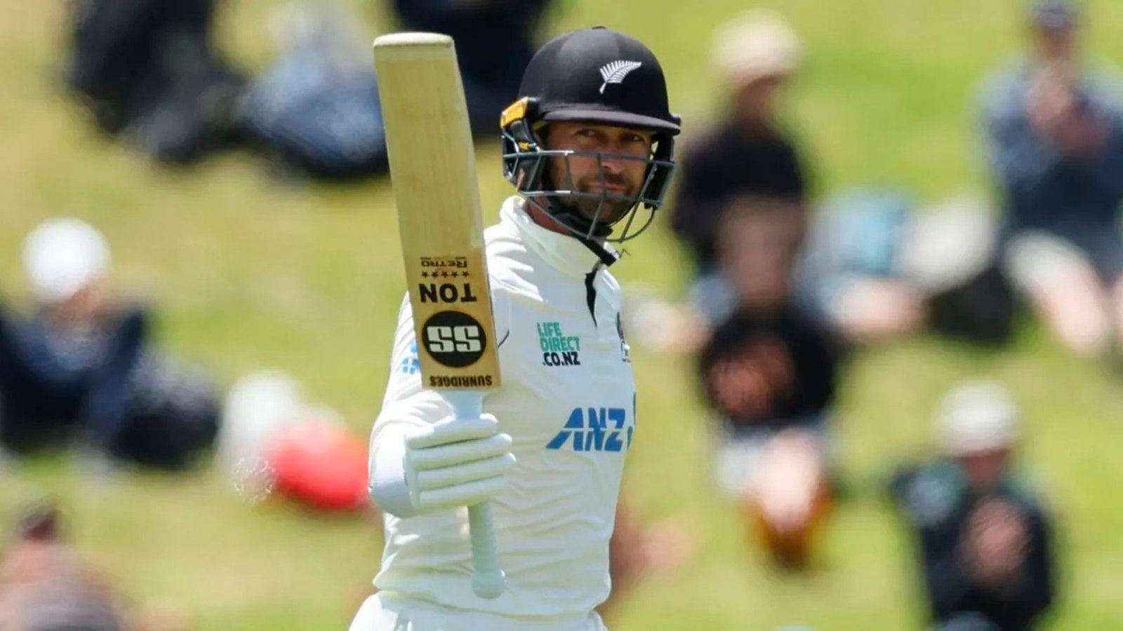 Devon Conway raises his bat after getting to his first half-century against West Indies • Getty Images